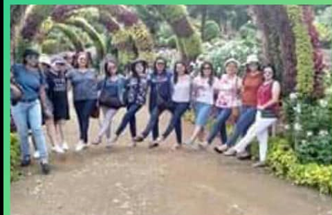 Group tour guests in a Cebu flower garden